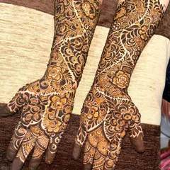 A beautiful example of a heavy Indo-Arabic design with a mix of floral, paisley, and geometric patterns creating a rich tapestry on the hands and arms.