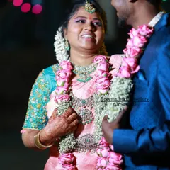A candid shot of the couple during their reception. The bride is wearing a sparkling AD jewellery set and her smile is absolutely infectious.
