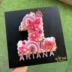 For Ariana's first birthday, I designed this pretty-in-pink number 1 monogram cake. It's decorated with buttercream swirls, custom acrylic rainbows, a little crown, and the birthday girl's name for a magical touch.