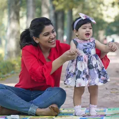 A daughter brings joyful moments to the present and hope for the future. This candid photo captures a mother and daughter sharing a moment during an outdoor park session.