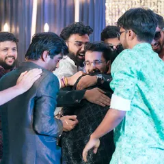 A big group hug for the groom from all his friends! A candid shot full of energy and friendship.