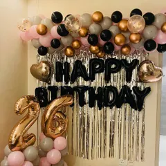 Another angle of the chic 26th birthday decor, showing the large rose gold number balloons and confetti-filled accent balloons.