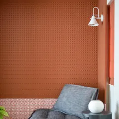 A full view of the terracotta nook, complete with a comfortable lounger and a small side table. It's the perfect spot to curl up with a book.