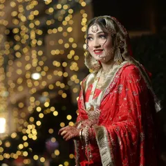 A beautiful candid portrait of bride Samiya against a backdrop of twinkling lights. The bokeh effect adds a magical, dreamy quality to the photo.