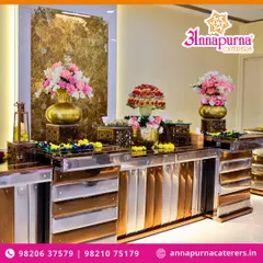Our buffet counters are designed to be a feast for the eyes. This setup features a mix of metallic and gold finishes, adorned with fresh flower arrangements and fruit displays, creating a luxurious look for any event.