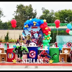 This poolside Avengers party for Nihaan's 5th birthday was a super celebration. I used character cutouts, shield and logo props, and a bold red and blue balloon arch to create a heroic backdrop for the party.