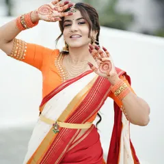 A playful and happy pose from Namratha Gowda, showing off her festive mehendi. The central mandala design on her palms is clearly visible and adds to the joyful mood.