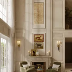 A close-up of the fireplace seating area within the grand dining room. The two moss-green velvet armchairs offer a comfortable spot for conversation before or after a meal, adding a touch of warmth to the formal space.
