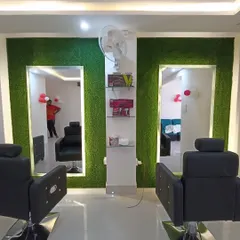 In this salon, I used artificial green panels to frame the mirror stations. This design choice adds a pop of color and a modern, natural element to the functional space.