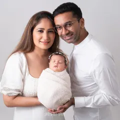 A classic family portrait with a newborn. Everyone is dressed in white for a clean, timeless look that keeps the focus on the love and connection within the family.