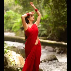 A different pose from the same outdoor shoot. The model's connection with the natural surroundings creates a feeling of freedom and grace.