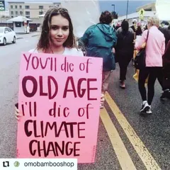 A young protestor holds a sign with a stark message: "You'll die of old age, I'll die of climate change." This image captures the generational stakes of the climate crisis and the frustration of a generation whose future is at risk.