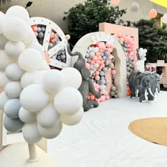 A glimpse of the pastel jungle theme, featuring a large balloon-filled arch and life-sized elephant props that create an exciting and immersive environment for kids.