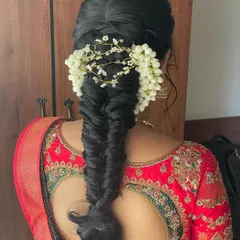 A beautiful fishtail braid woven with fresh jasmine flowers (gundu malli). This is a timeless and fragrant choice for any traditional ceremony.