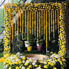 A closer look at the beautiful marigold and white floral arrangement for a Haldi ceremony. I used a green wall as the base to make the yellow colors pop, creating a perfect backdrop for photos.