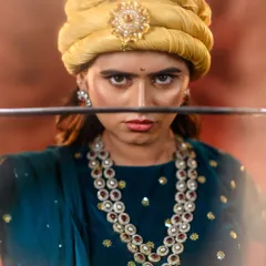 It's more than a costume; it's about embodying a character. Here, we capture the fierce intensity of Rani Lakshmibai, with a focus on the determined expression, period-accurate pagri, and the powerful presence of the warrior queen.