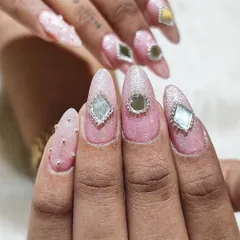 A detailed close-up of the mirror-work inspired Navratri nails. The combination of a textured glitter base and reflective gems creates a stunning, eye-catching effect.