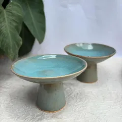 We've been experimenting with new forms, like these elevated plates or shallow bowls. They're perfect for serving desserts, appetizers, or as a beautiful centerpiece.