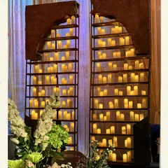 A statement candle wall, designed to be a showstopper. These installations frame the celebration with an aura of romance, casting a warm, golden light that makes the entire room feel intimate and indulgent.