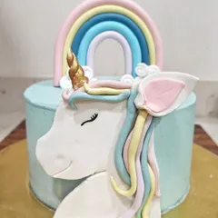 A magical unicorn cake that's perfect for a child's birthday. I used fondant to create the unicorn's head, complete with a pastel mane and a shimmering golden horn.