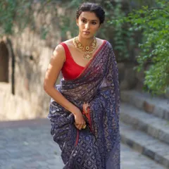 A beautiful shot of a model in a classic navy blue and red saree. This is from a collaboration where we focused on creating a timeless and elegant look.