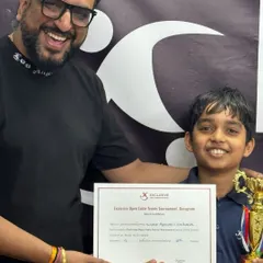 This is the moment it's all for. A huge smile from one of our young champions holding his well-earned trophy and certificate from our Exclusive Open Table Tennis Tournament. Seeing this joy is what drives me.