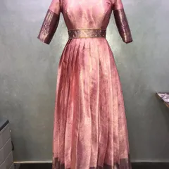 An elegant Anarkali gown made from a pink pattu saree. I carefully used the original saree border on the sleeves and hem for a complete, traditional look.