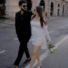 Walking arm in arm, they share a look that feels both candid and cool. This shot, taken as they cross the street, has a natural, unposed quality that I strive for in my urban pre-wedding photography sessions.