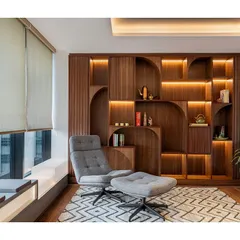 A closer look at the custom bookshelf in the wellness zone of the IHCL office. The design features integrated lighting within its arched and linear compartments, creating a warm and inviting atmosphere.