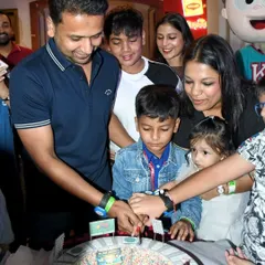 The whole family gathers to help Prishiv cut his unique 8th birthday cake. It was a home run of a celebration.