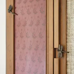 A close-up of custom wardrobe doors featuring dragonfly-shaped handles. These small, artisanal details add a layer of personality and craft to the furniture, transforming a simple storage unit into a piece of art.