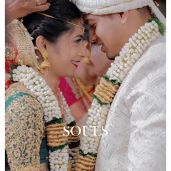 Two souls connecting amidst the sacred rituals. This image captures the quiet intimacy and shared look between the couple, a moment of peace during the wedding ceremony.