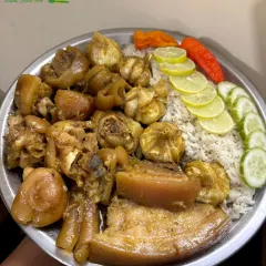 A succulent plateful of boiled pork ribs and trotters, served with rice and fresh lemon and cucumber.
