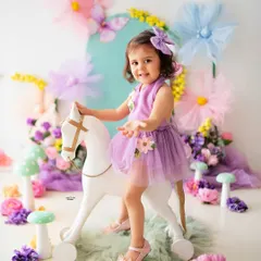 Let's bring your imagination to life! This whimsical fairy garden theme is a perfect example of the creative toddler photoshoots I love to design. With pastel colors, fun props like this rocking horse, and a touch of magic, we can create a fairytale world for your little one.