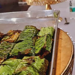 This dish is our Paneer Paturi, where marinated cottage cheese is wrapped in banana leaves and steamed or grilled. This technique infuses the paneer with a unique, earthy aroma.