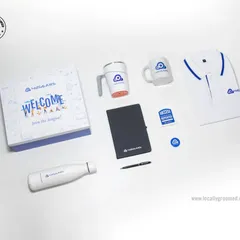This welcome kit for 42Gears includes a branded polo t-shirt, a water bottle, a spill-proof suction mug, a classic ceramic mug, a notebook and pen, and custom badges, all presented in a "Welcome to the League" box.