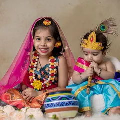 Two siblings dressed as Radha and Krishna for a Janmashtami themed studio shoot. I provide the costumes and props to make these festive portraits perfect.