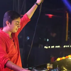 On the mic during a Diwali event, with my hand raised to hype the crowd. I'm always ready to guide the energy of the room.