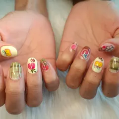One of my clients brought in a picture of another artist's nails, and I loved recreating the look. This set features a variety of quirky, hand-painted designs on each nail.