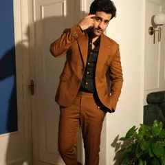 For Satyajeet Dubey, I designed this impeccably tailored brown formal suit. The silhouette is defined by a broad notch lapel and precise buttonhole detailing, showcasing the artistry in classic menswear.