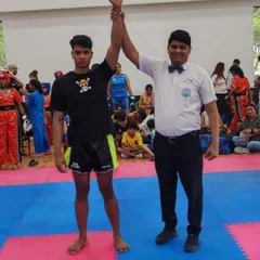 Victory declared. A StrikeHive student is announced the winner at the WAKO India Kickboxing Federation district championship.