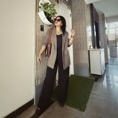 A perfect example of modern power dressing. This look combines a structured blazer with elegant wide-legged pants, creating a silhouette that is both authoritative and chic for the corporate environment.