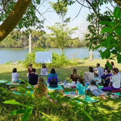 A teaching practice session by the river. Our 200-hour YTT graduates gain the confidence and skills to lead their own classes.