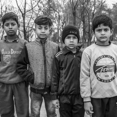 I asked this group of boys to stand for a photo. Even in a posed shot, their individual personalities shine through. Black and white helps unify the image and highlight their expressions.