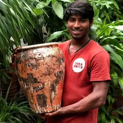 One of our team members proudly holding a piece from our latest range of textured terracotta pots. Each one is a unique, rustic beauty.