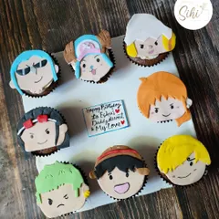 I was so excited to make this One Piece anime set. Each cupcake features a different character from the Straw Hat crew, like Luffy and Zoro, all hand-crafted from fondant.