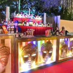 A full view of our stylish mocktail bar. The illuminated masks create a unique and festive ambiance, perfect for an engagement party or sangeet.