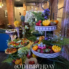 Celebrating a 60th birthday calls for something truly special. This multi-tiered grazing table was a vibrant centerpiece, filled with an abundance of fresh fruits, gourmet bites, and decorative elements to honor the milestone moment.