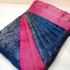 The contrast of navy blue and bright pink on this silk saree is stunning. The pleats are neatly arranged to showcase the intricate silver brocade work.