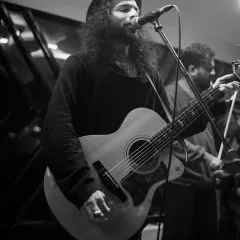 A guitarist performing as part of the live fusion experience. These collaborations are perfect for sangeets, corporate events, or any party that wants something extra special.